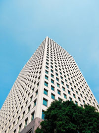 Low angle view of modern building against clear blue sky