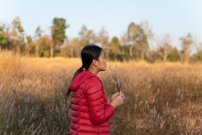 Side view of woman standing on field