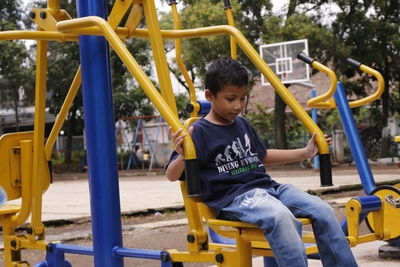 Boy exercising in park