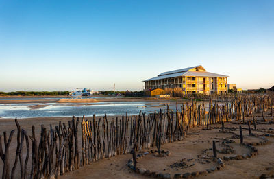 Scenic view of beach against clear blue sky