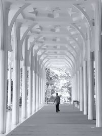 Rear view of woman walking in corridor