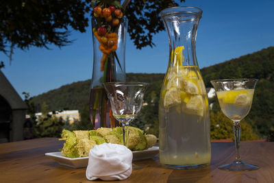 Close-up of food and drink on table at dusk