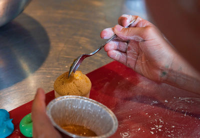 Close-up of person preparing food on table