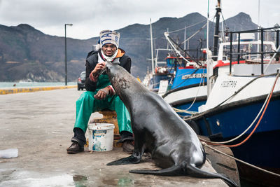 Man with seal by marina