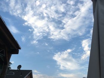 Low angle view of house against cloudy sky