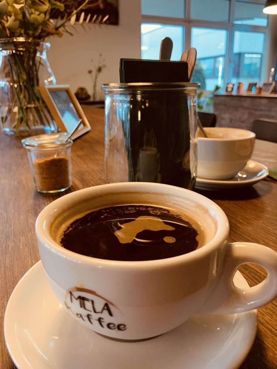 CLOSE-UP OF COFFEE CUP AND TEA ON TABLE