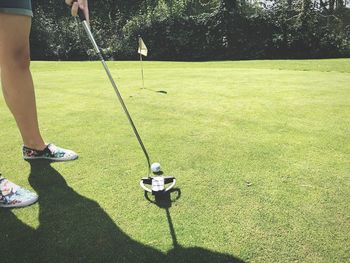 Low section of woman playing on golf course