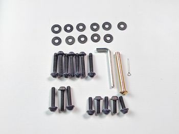 High angle view of bolts and screws on white background