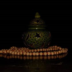 Close-up of illuminated lamp against black background