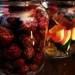 Close-up of fruits in glass jar on table