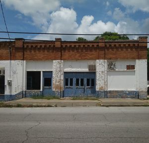 View of abandoned building against cloudy sky