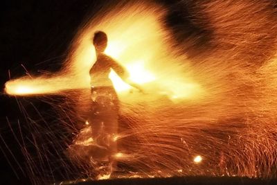 Blurred motion of woman at night