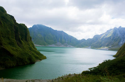 Scenic view of mountains against cloudy sky