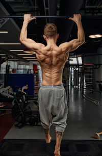 Rear view of man exercising in gym