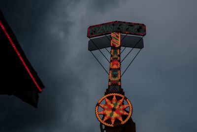 Low angle view of illuminated hanging against sky