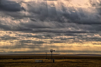 Colorado plains with storm clouds and windmill