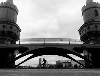 Low angle view of bridge against cloudy sky