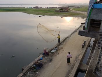 High angle view of people fishing in lake