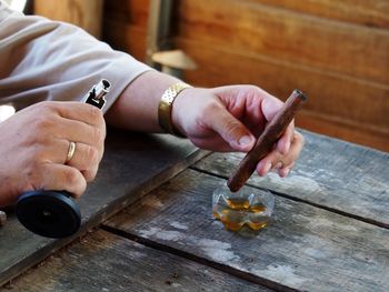 Man holding cigarette on table