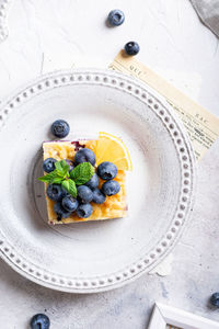 Blueberry pie with cottage cheese on white plate