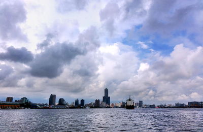 Panoramic view of sea and buildings against sky