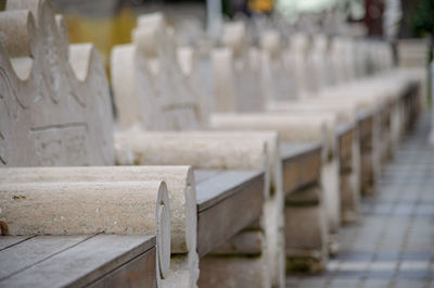 Close-up of empty benches in row