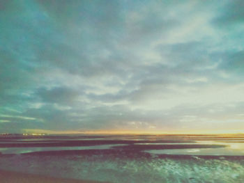 Scenic view of beach against sky during sunset