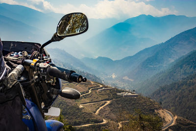 Bike at mountain valley with mountain curvy road at morning form flat angle 