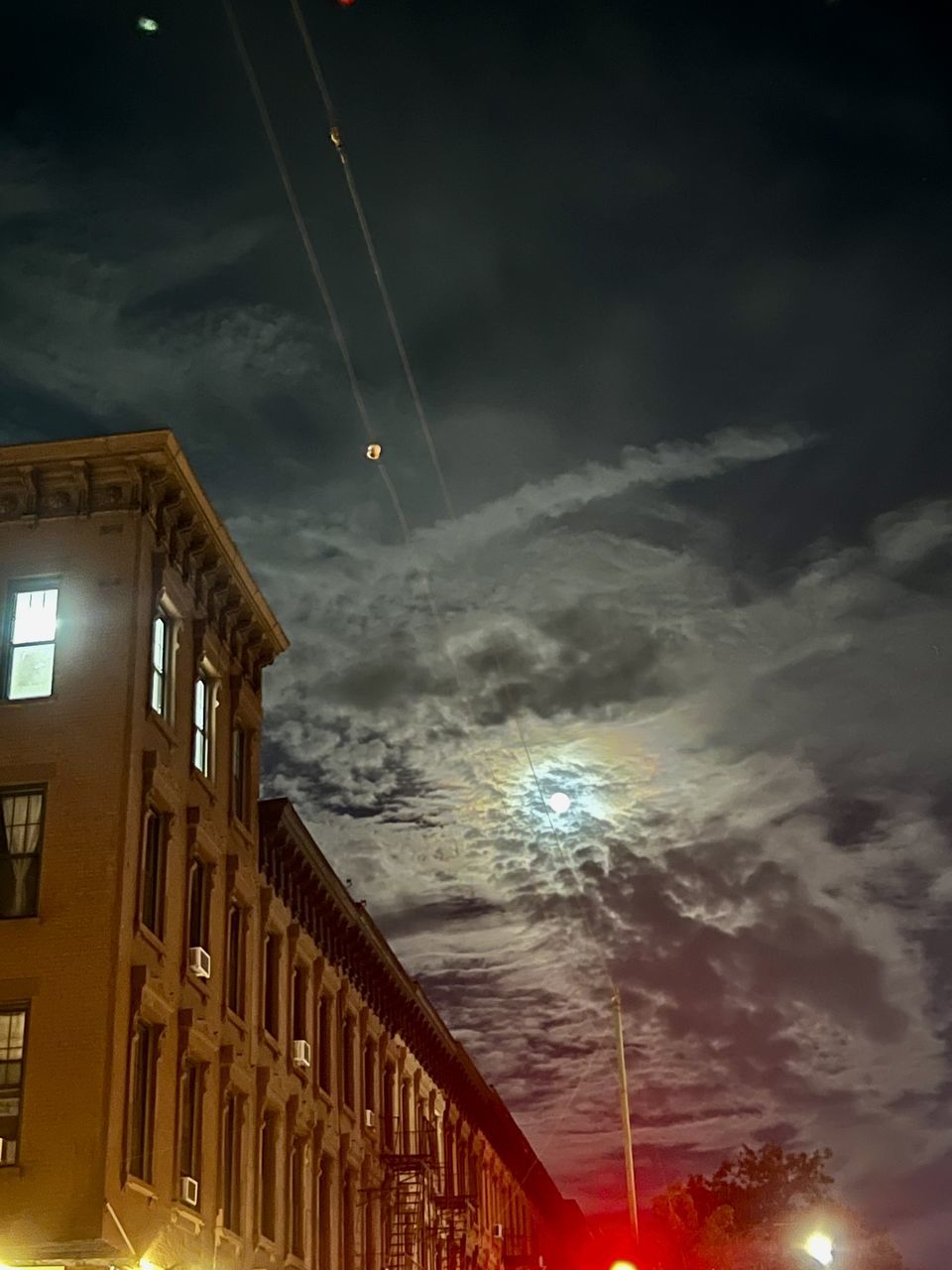 sky, night, cloud, architecture, light, illuminated, built structure, building exterior, evening, nature, low angle view, city, darkness, no people, building, motion, dusk, storm, outdoors, fireworks, transportation, long exposure, street