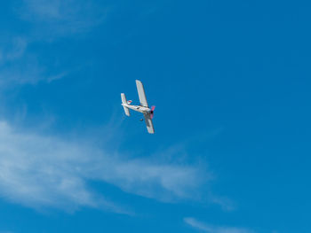 Low angle view of airplane flying in sky