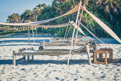 Close-up of camp beds on beach