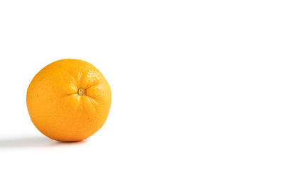 Close-up of orange apple against white background