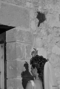 Portrait of girl against wall