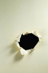 Close-up of broken glass against white background