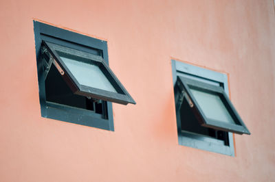 Low angle view of window on wall of building