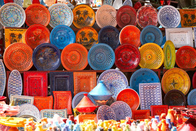 Multi colored antique plates for sale at market stall