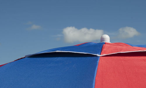 Low angle view of parasol against sky