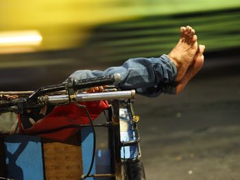 Low section of person in shopping cart at night