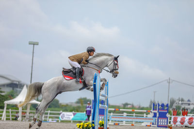 Horse riding motorcycle against sky