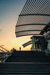 Low angle view of silhouette staircase against sky during sunset