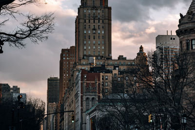 Buildings in city against sky at sunset