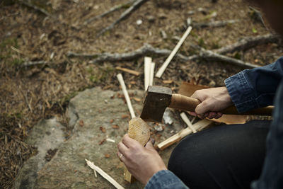 Hands with axe chopping wood