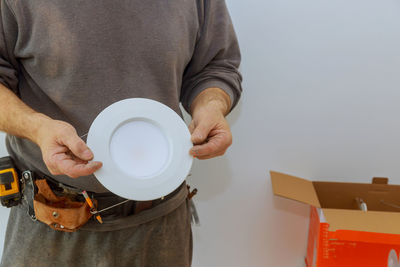 Midsection of man holding ice cream