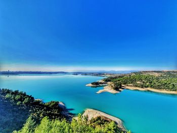 Scenic view of sea against clear blue sky