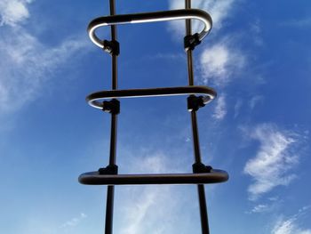 Low angle view of silhouette pole against sky