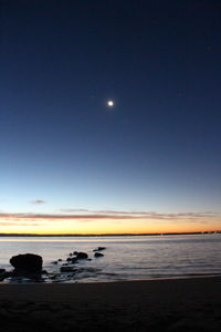 Scenic view of sea against sky at night