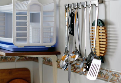 Utensils hanging in kitchen at home