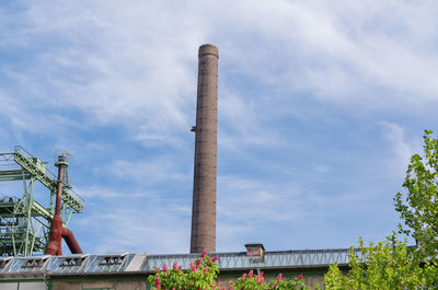 Low angle view of smoke stack against sky