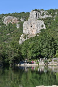 Scenic view of lake by trees against sky