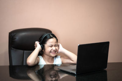 Portrait of smiling girl using mobile phone